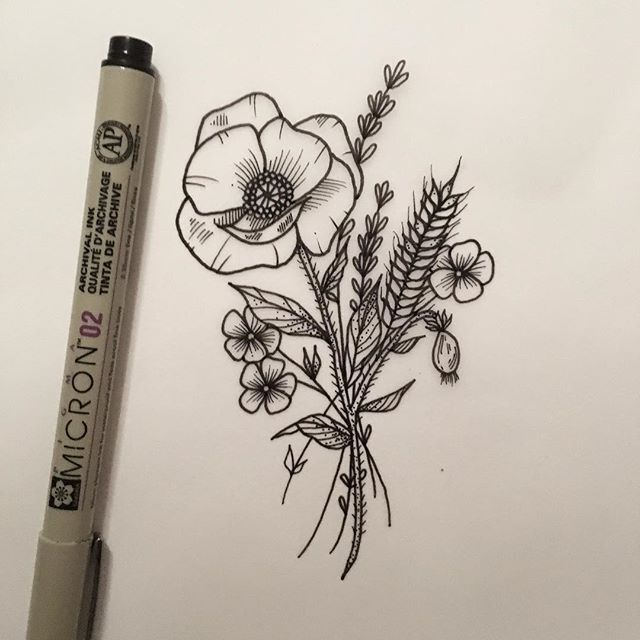 a drawing of some flowers on a sheet of paper next to a marker and pen