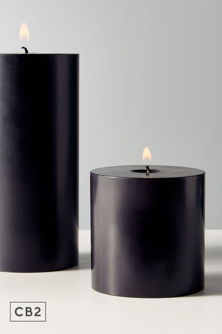 two black candles sitting next to each other