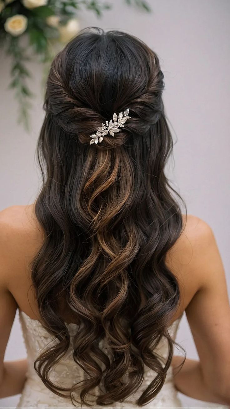 the back of a woman's head with long wavy hair and a flower in her hair