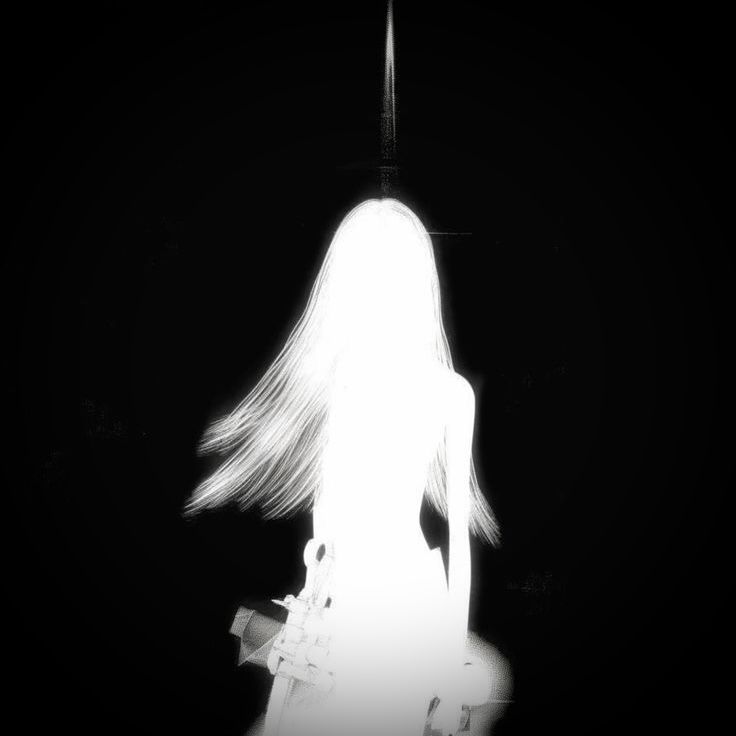 a woman with long white hair standing in the dark