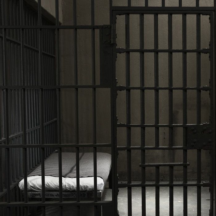 a jail cell with a mattress in it