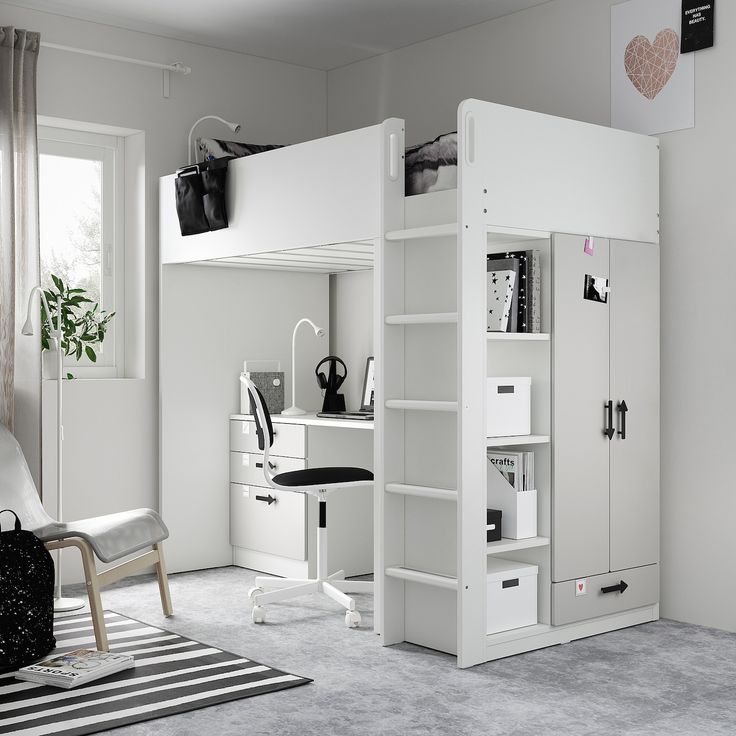 a white loft bed sitting next to a desk