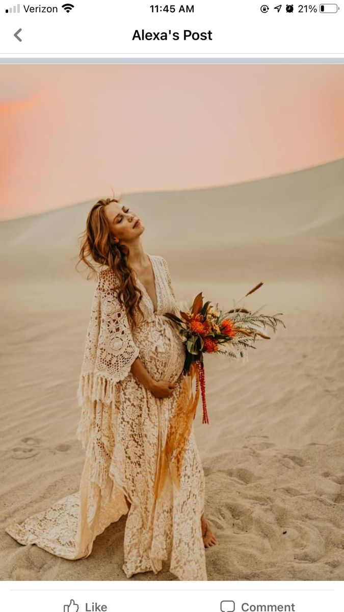 a woman standing in the sand holding a bouquet