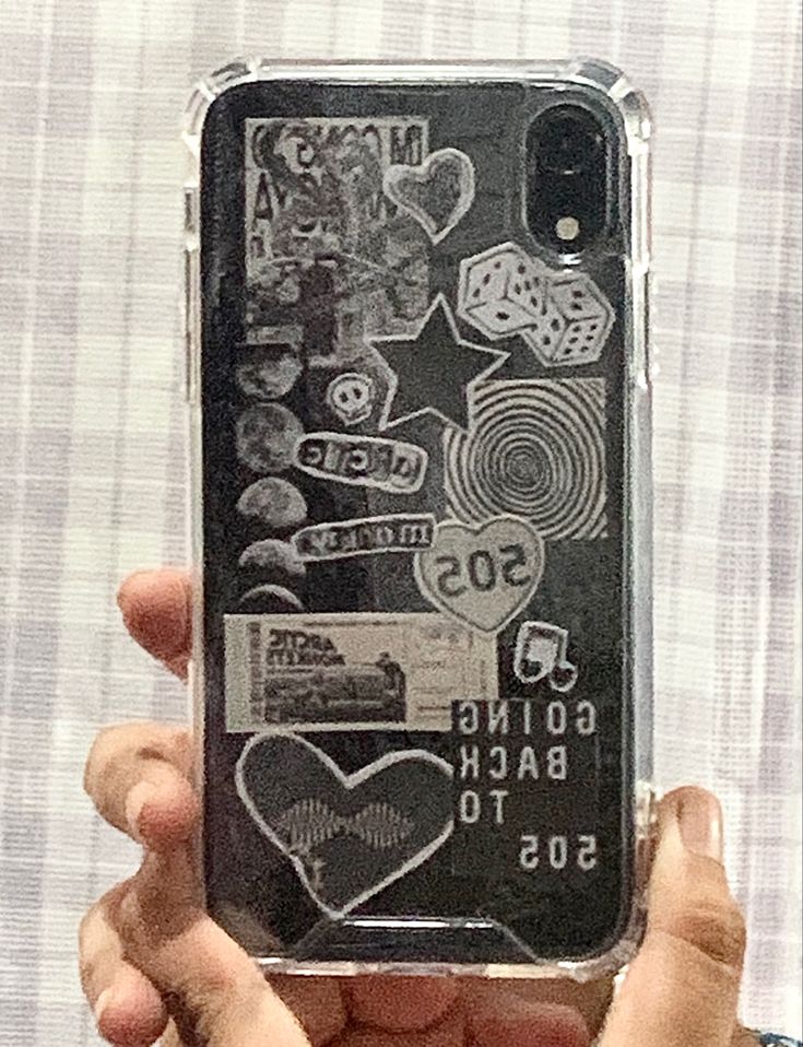 someone is holding up their phone case with some stickers on the back and sides