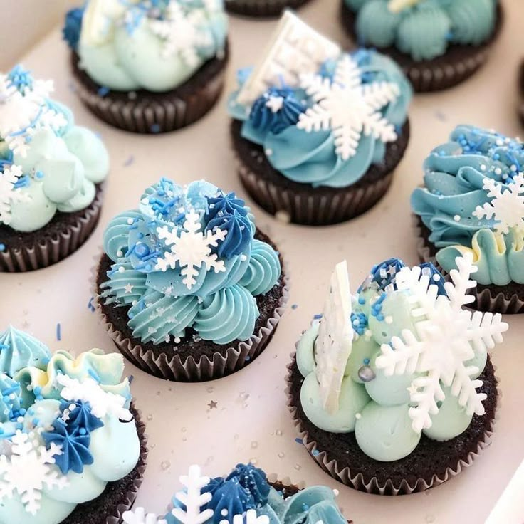 cupcakes decorated with blue frosting and snowflakes