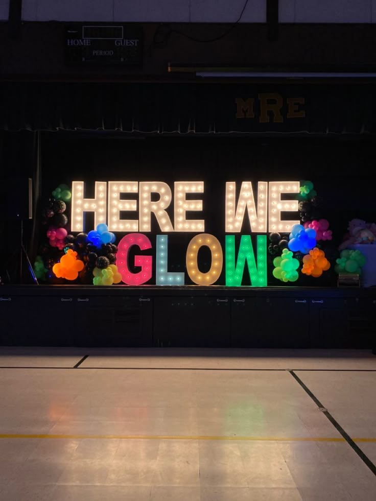 there is a neon sign that says here we glow