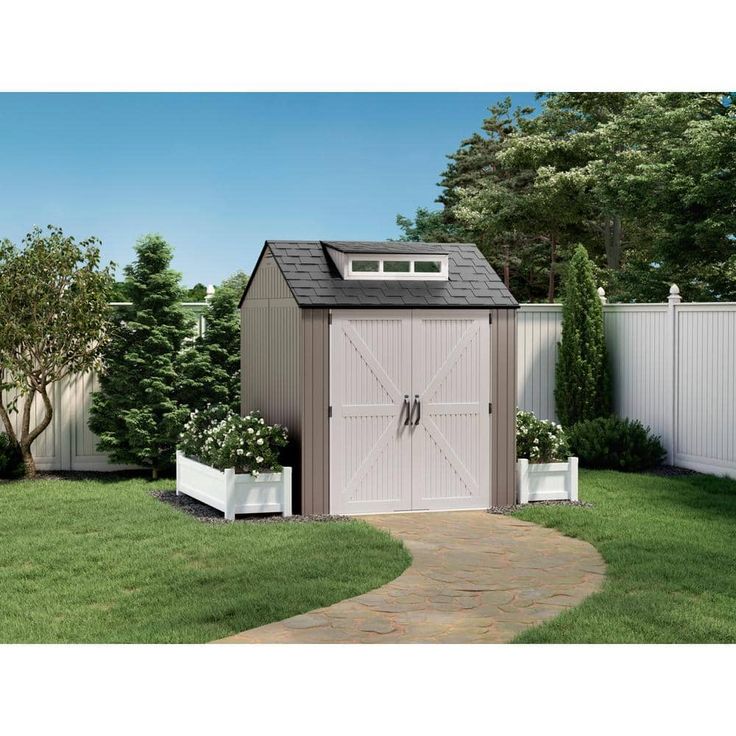 a small shed in the middle of a yard with a path leading up to it