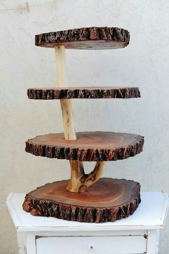 three tiered tree slice cake stand on top of a white table