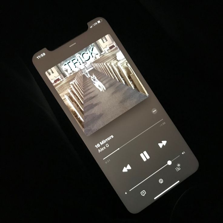 an image of a cell phone with music playing on it's screen in the dark