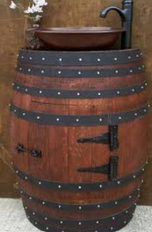 a large wooden barrel with a sink in the middle and flowers growing out of it