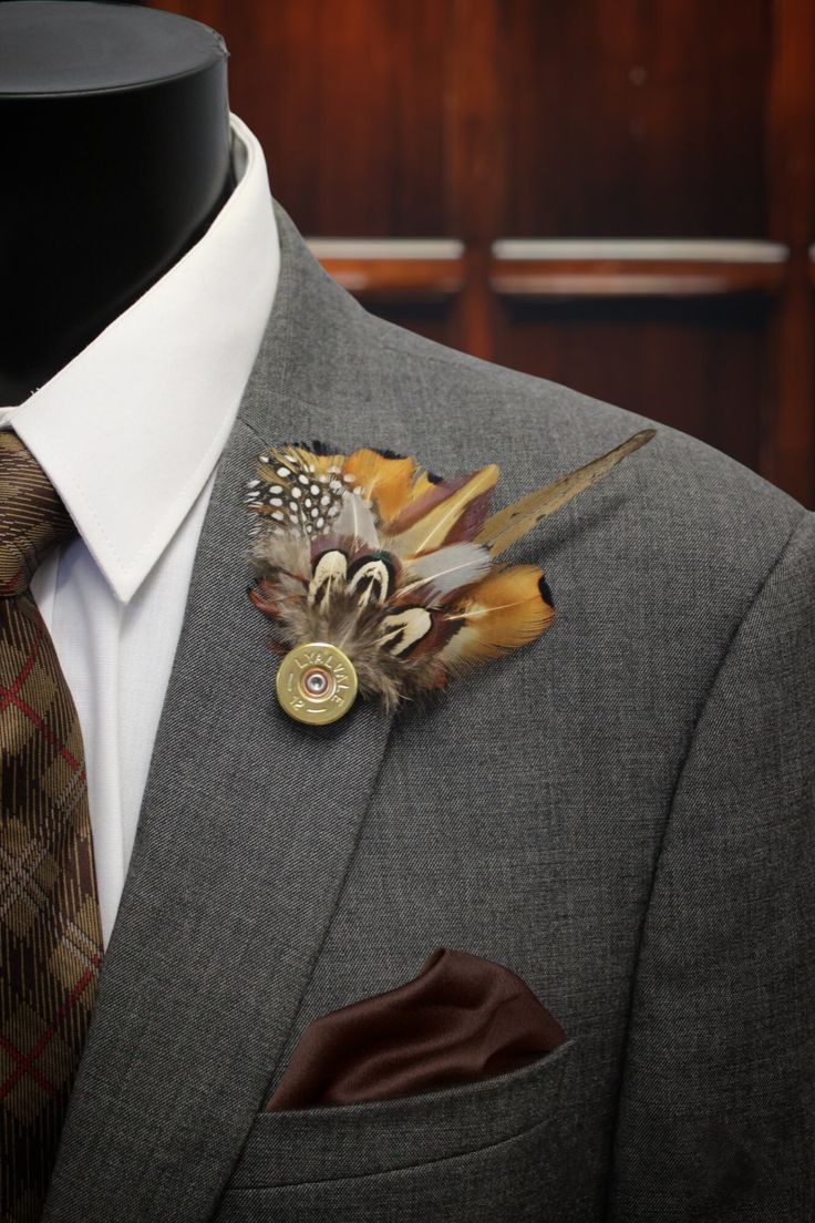 a man wearing a suit and tie with a boutonniere on his lapel