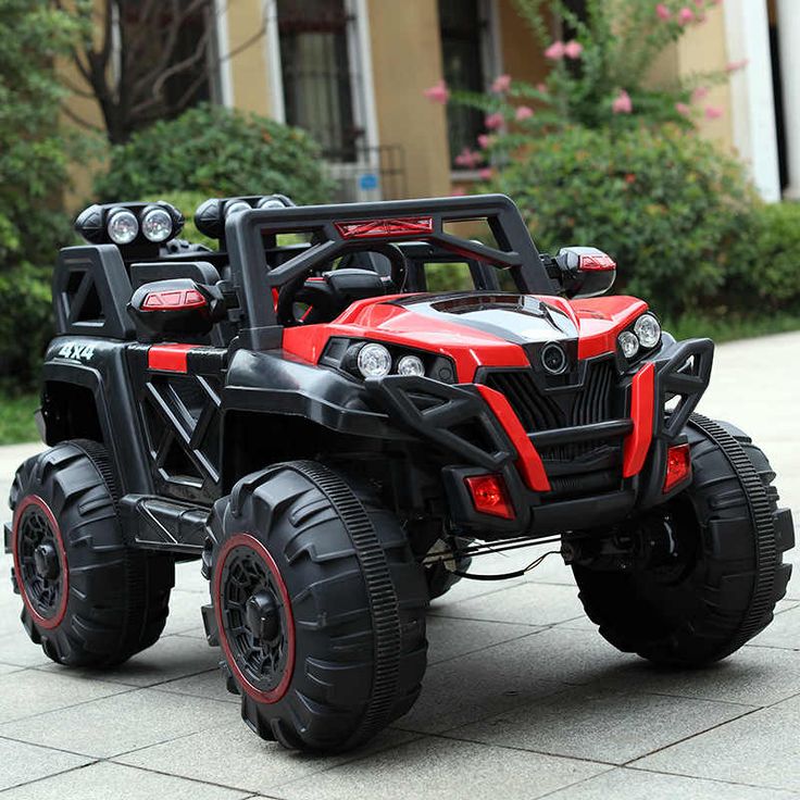 two children's toy atvs are parked on the sidewalk in front of a house