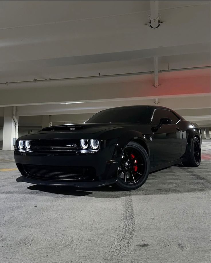 a black car parked in a parking garage