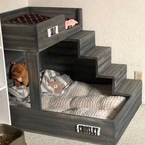 a child's bed made out of pallets with a stuffed animal in it