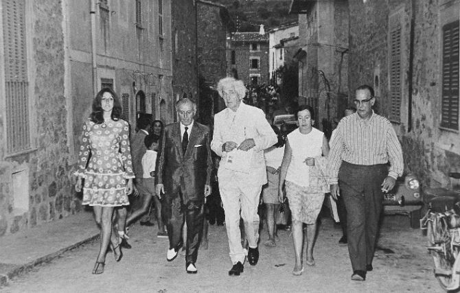 black and white photograph of people walking down the street