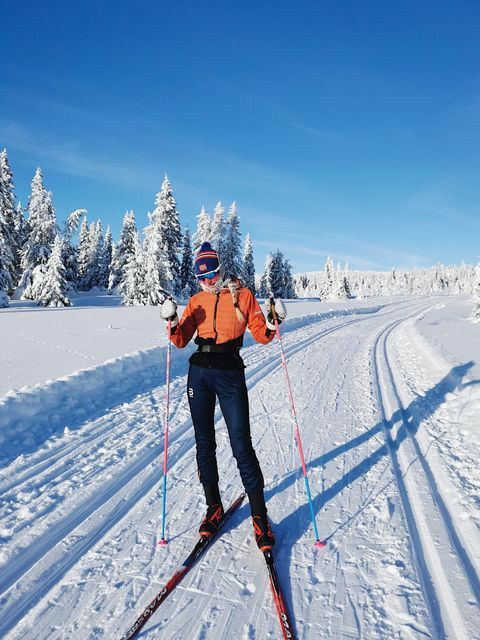 a man riding skis down a snow covered slope