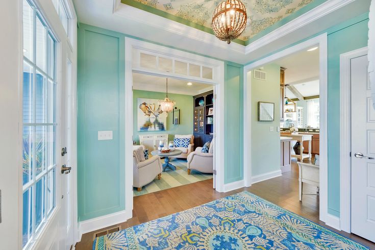 a living room filled with furniture and a blue rug