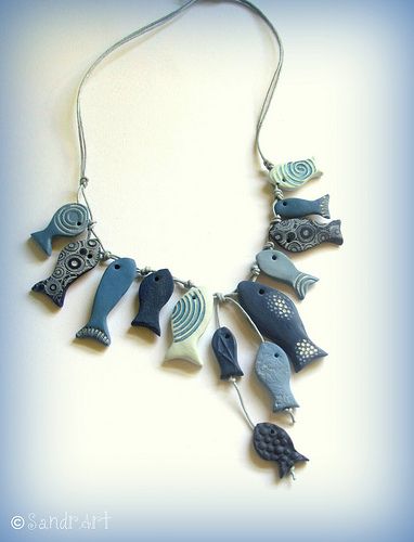 a blue and white necklace with birds on it