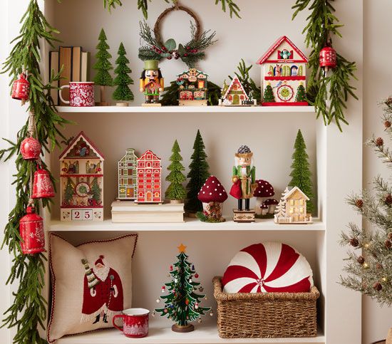 christmas decorations are displayed on shelves in the corner of a room with trees and other items