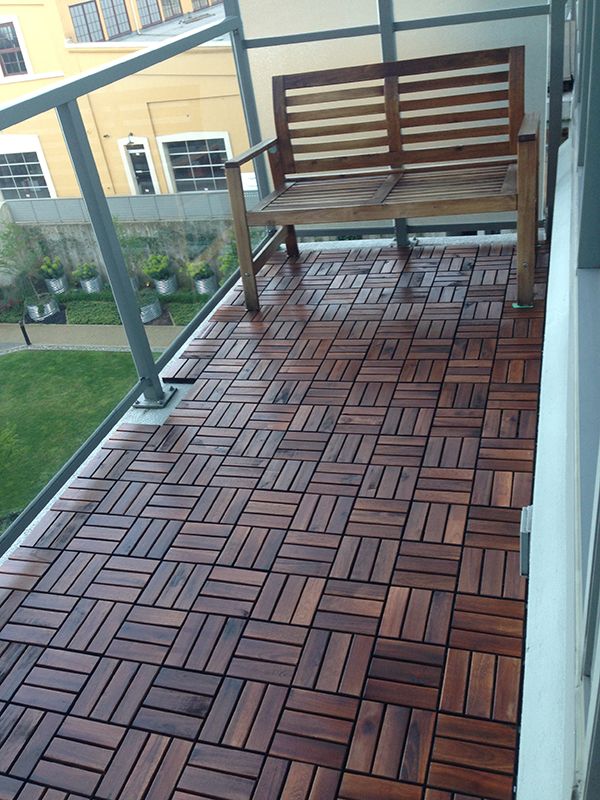 a wooden bench sitting on top of a balcony