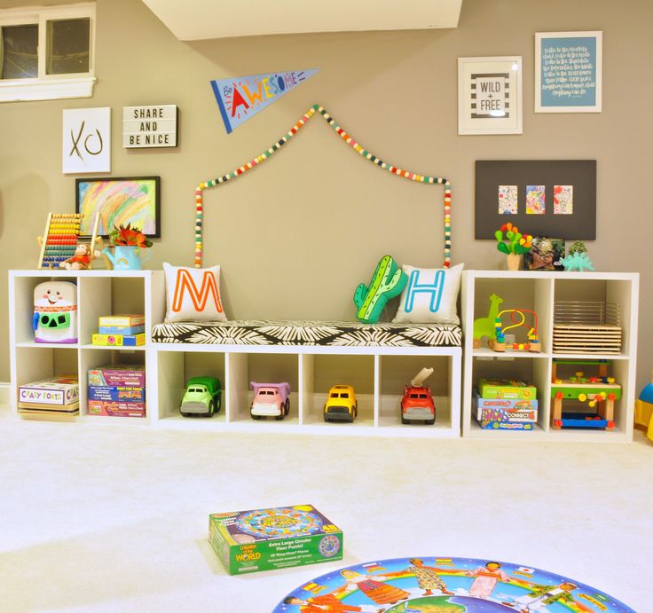 a child's playroom with toys and bookshelves on the floor in front of it