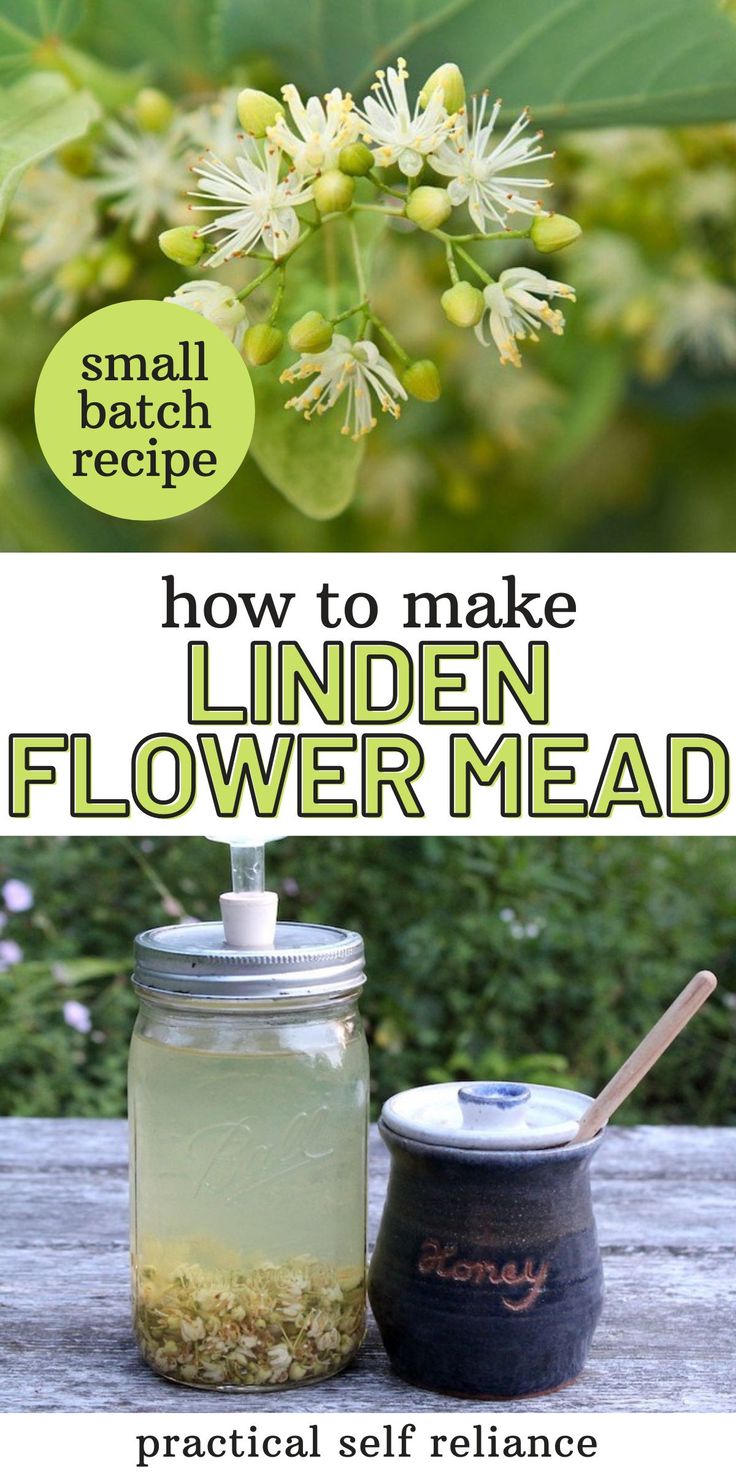 a jar filled with flowers sitting on top of a wooden table next to a spoon