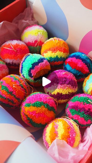 a box filled with colorful donuts covered in sprinkles and colored paper