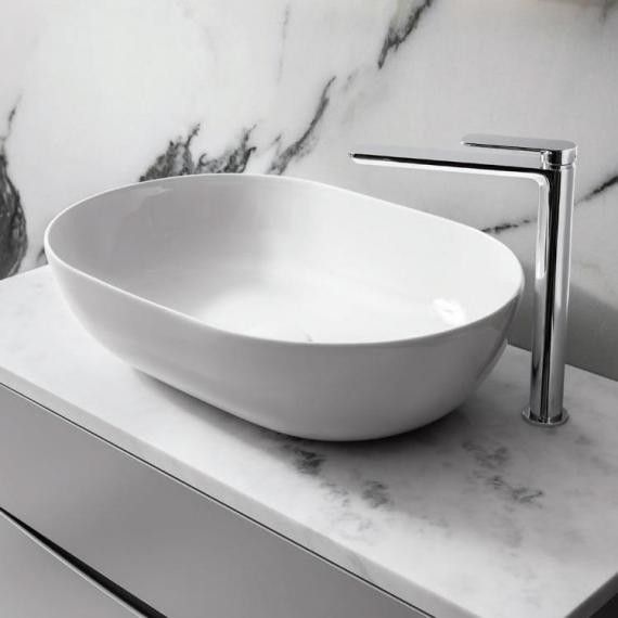 a white bowl sink sitting on top of a counter next to a faucet