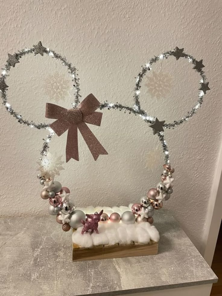 a close up of a mickey mouse head with pearls and bows on it's ears