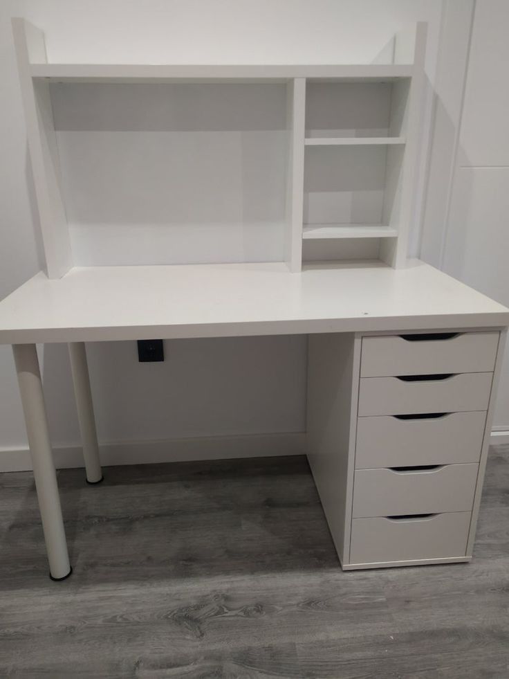 a white desk with drawers and shelves on it