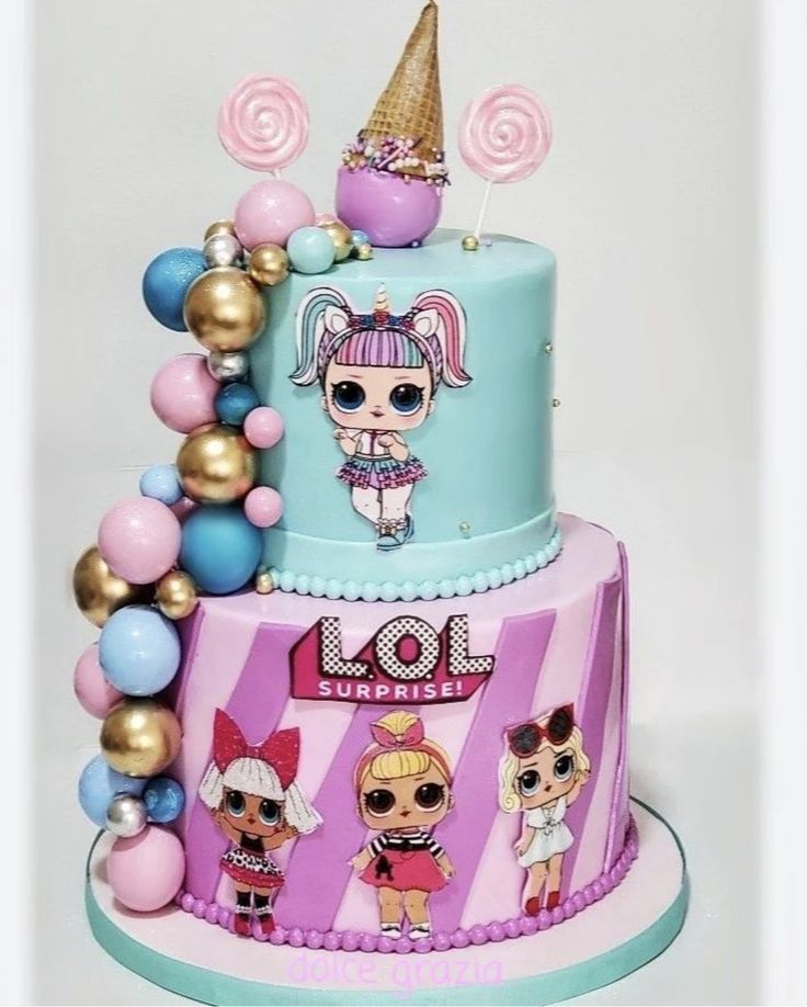 a multi layer birthday cake decorated with lol dolls and candy decorations on top of it