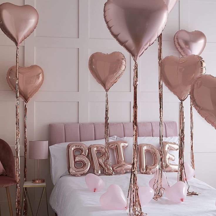 pink and gold balloons in the shape of heart shaped balloons with bride written on them