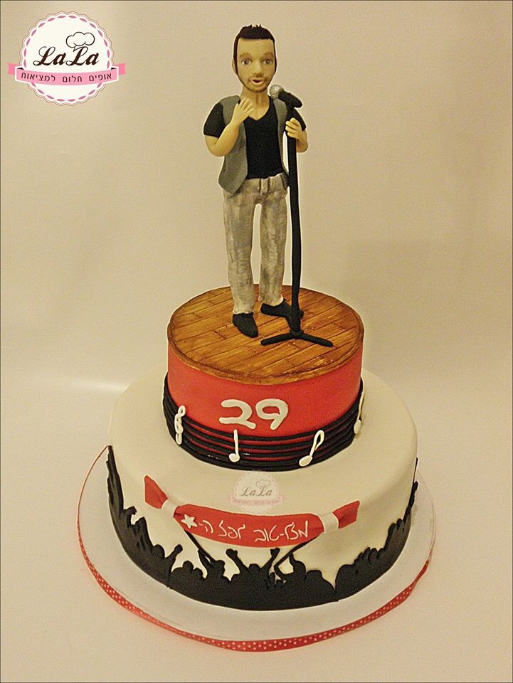 a cake with a figure on top of it and the number 29 written in white