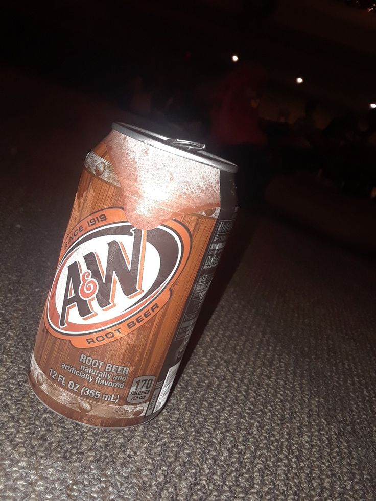 a can of beer sitting on the floor