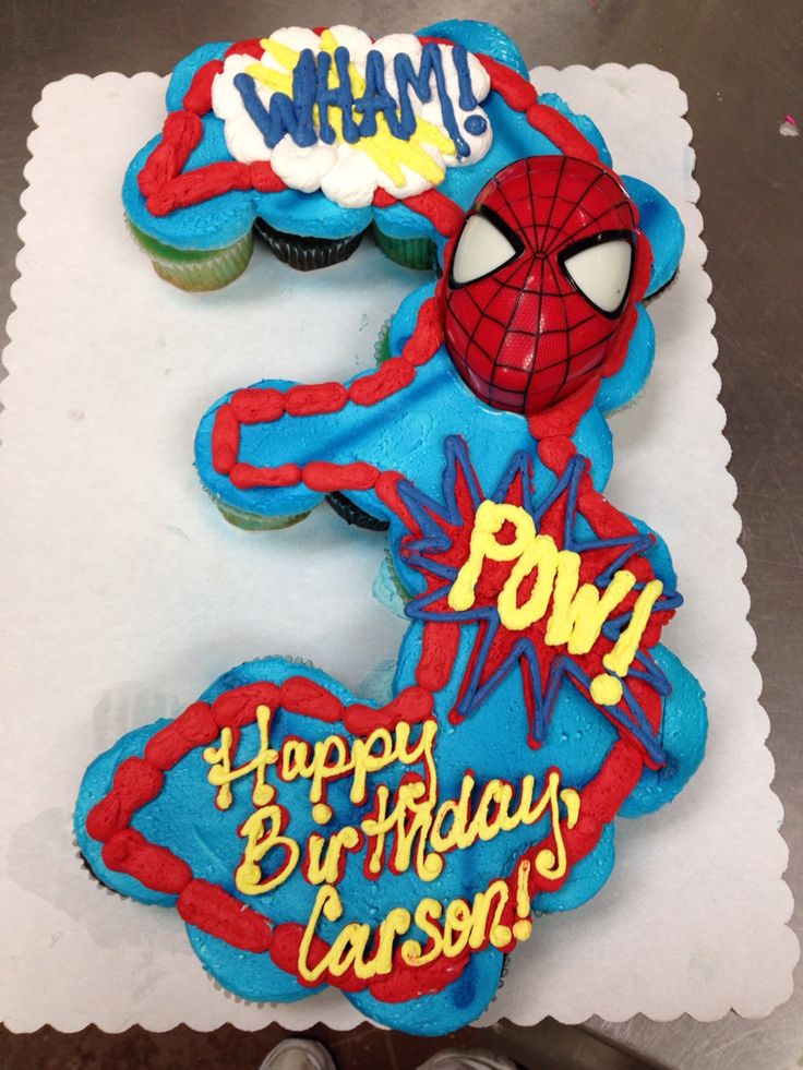 a spiderman birthday cake with cupcakes on the top, and an inscription that says pow happy birthday cassse