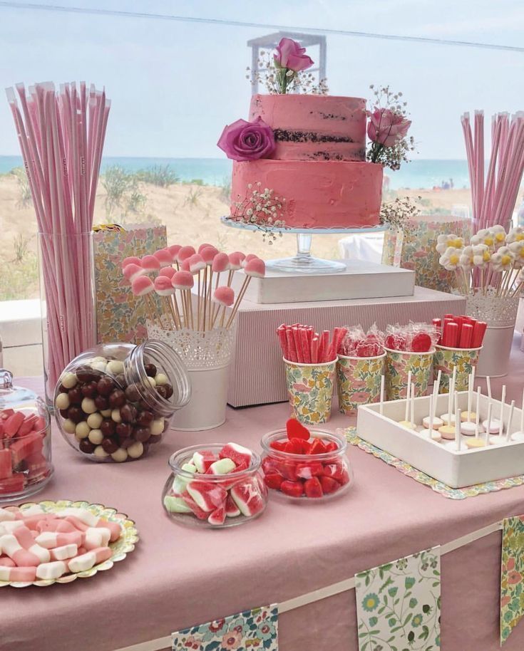 a table topped with lots of desserts and candies on top of it's sides