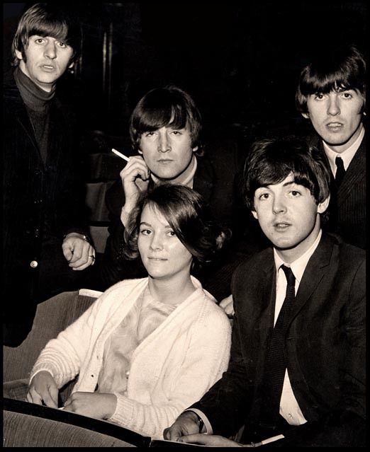 the beatles are posing for a photo in black and white