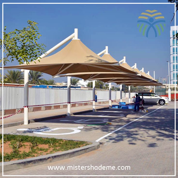 an outdoor area with tables and umbrellas