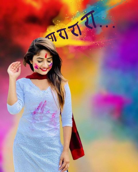 a woman with painted face and body standing in front of a colorful background that says happy holi