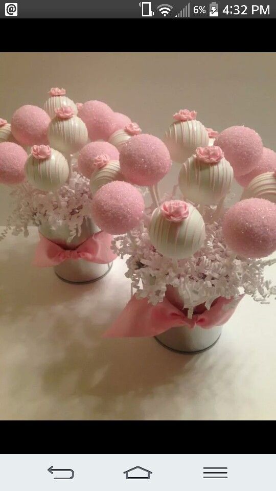 pink and white candy balls in vases with flowers