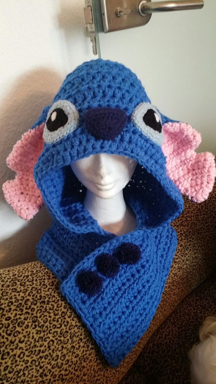 a crocheted blue hat and scarf on top of a mannequin head