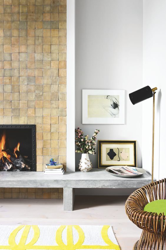 a living room with a fireplace and pictures on the wall