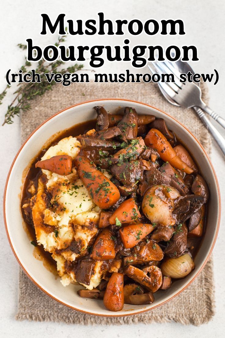 a bowl filled with meat and vegetables on top of a table next to a spoon