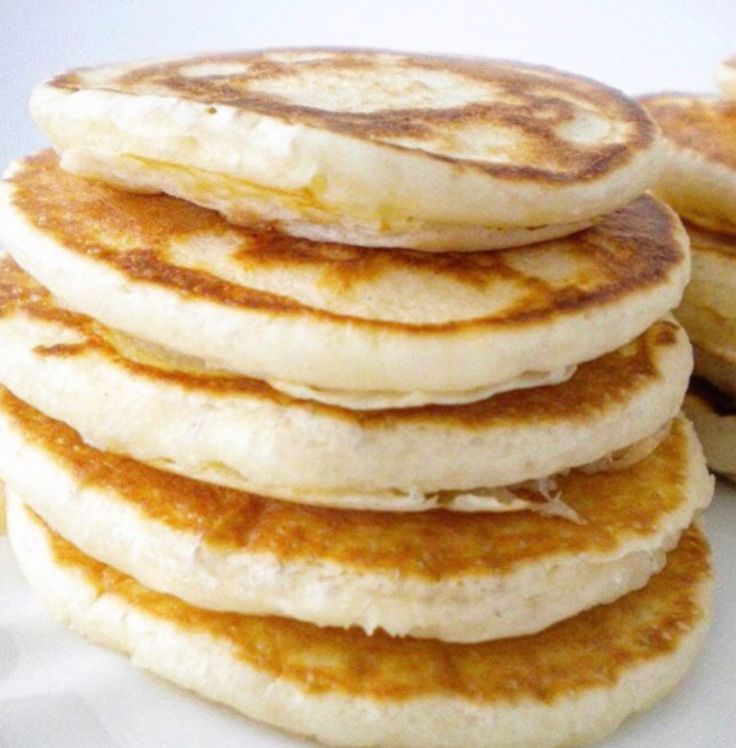 a stack of pancakes sitting on top of a white plate