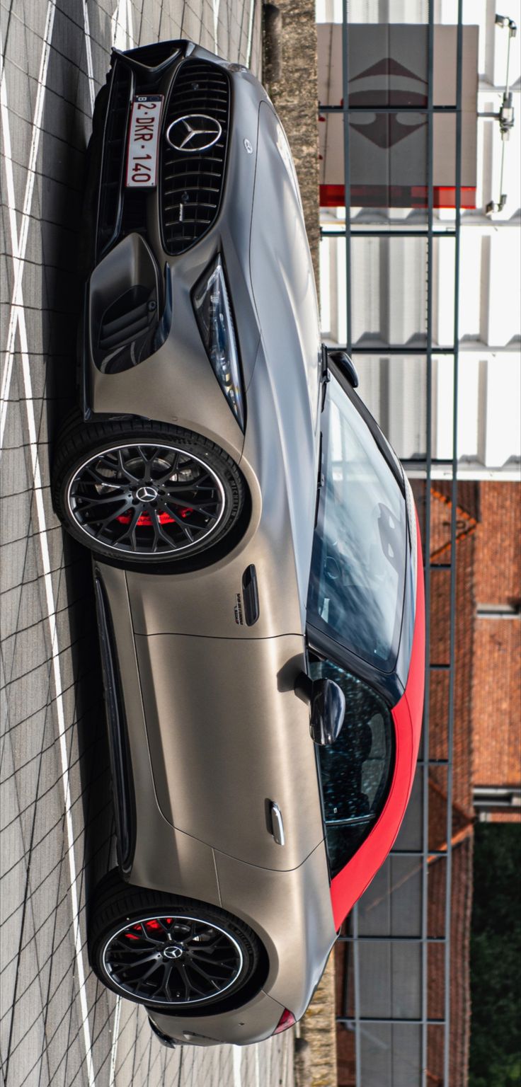 a silver sports car parked on the side of a building