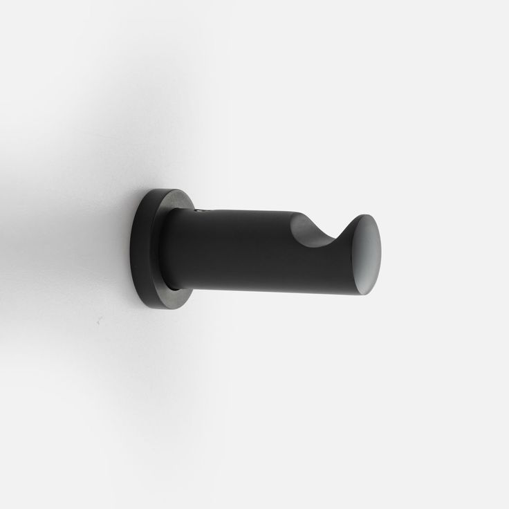 a black handle on a white wall