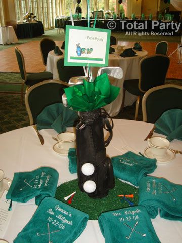 a golf themed centerpiece sits on top of a table at a corporate event,