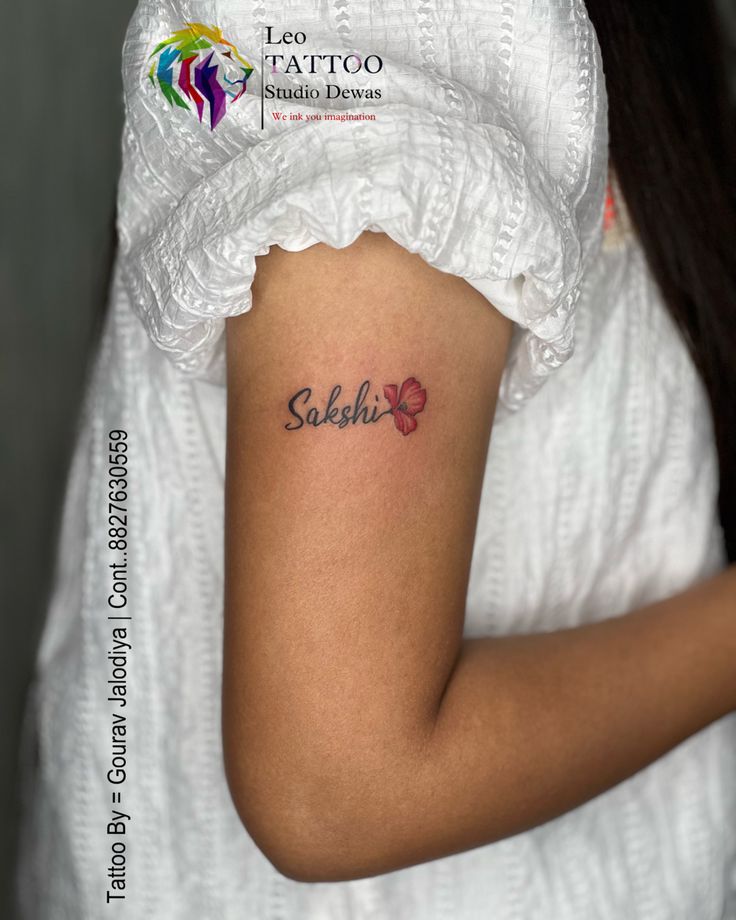 a woman with a small tattoo on her arm that says sekiko in cursive letters