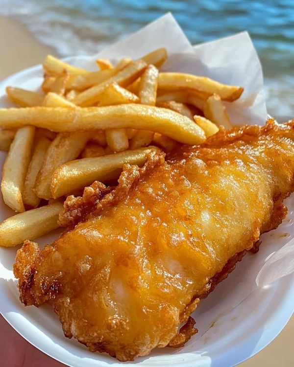 a white plate topped with french fries and chicken