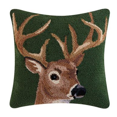 a pillow with a deer's head on the front and green background, which is made out of sequins